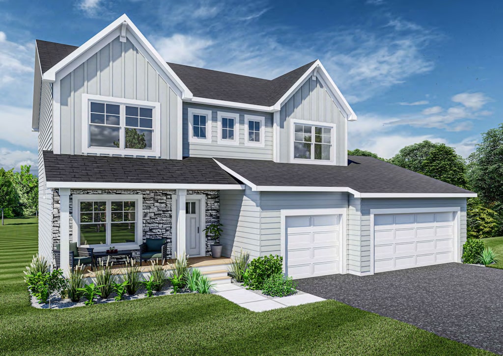 view of front facade with covered porch, a front yard, and a garage