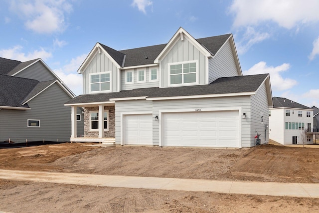 11459 Blazingstar Ln, Lake Elmo, MN 55042 - craftsman house with board and batten siding, a garage, dirt driveway, and stone siding