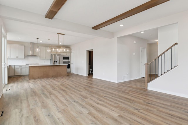 11459 Blazingstar Ln, Lake Elmo, MN 55042 - unfurnished living room with beamed ceiling, recessed lighting, light wood-style floors, baseboards, and stairway