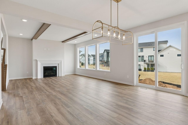 11459 Blazingstar Ln, Lake Elmo, MN 55042 - unfurnished living room featuring wood finished floors, baseboards, recessed lighting, beamed ceiling, and a glass covered fireplace