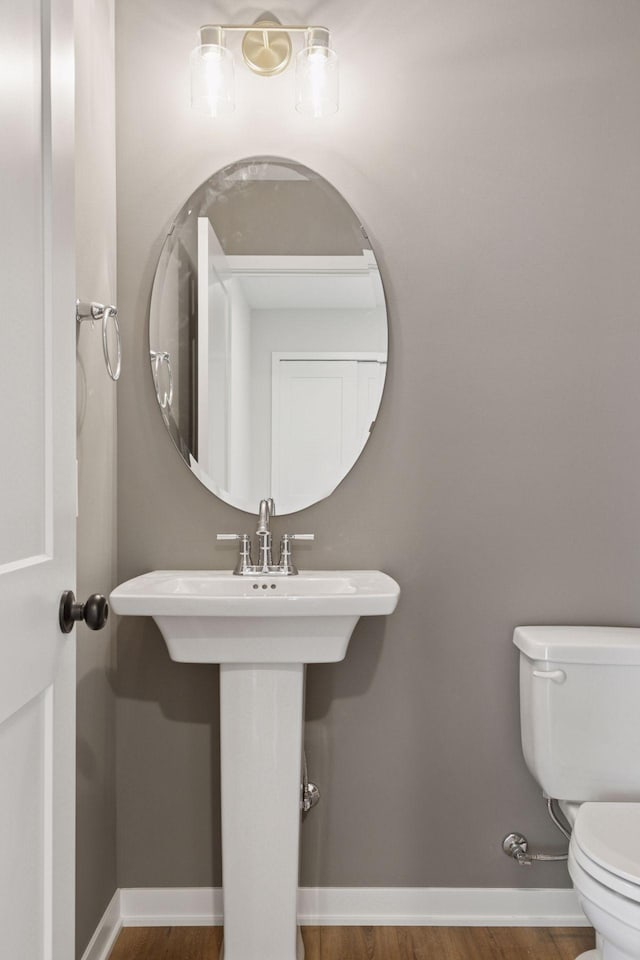 11459 Blazingstar Ln, Lake Elmo, MN 55042 - bathroom featuring toilet, wood finished floors, and baseboards