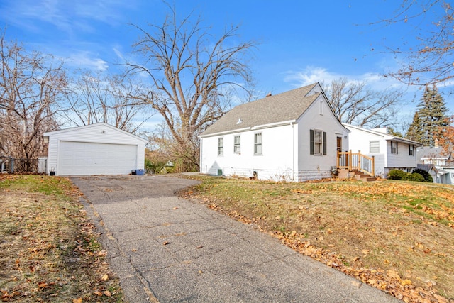 view of home's exterior with an outbuilding, a garage, and a lawn