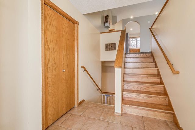 staircase with tile patterned floors