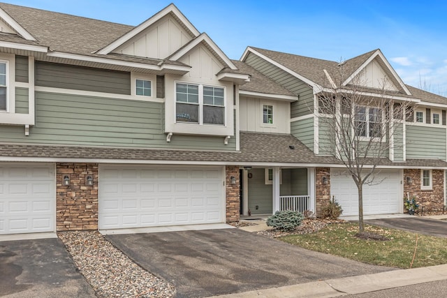 townhome / multi-family property with covered porch and a garage