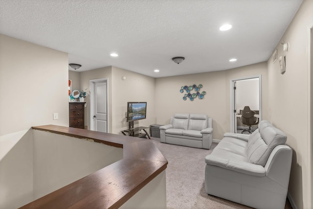 living room with light carpet and a textured ceiling