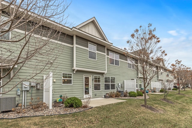 back of property featuring a lawn, a patio, and central AC unit