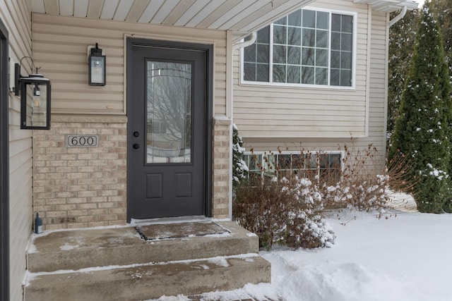 view of snow covered property entrance