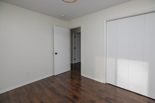 unfurnished bedroom featuring dark hardwood / wood-style flooring