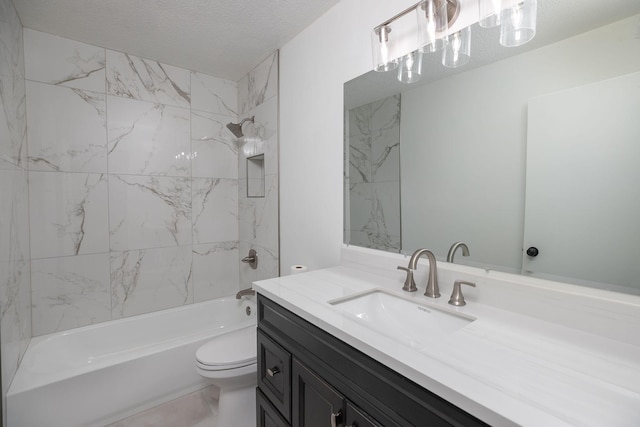 full bathroom featuring vanity, a textured ceiling, toilet, and tiled shower / bath