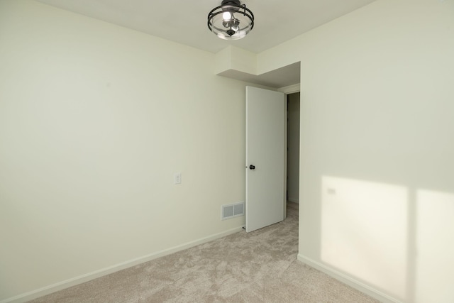 unfurnished room with light carpet