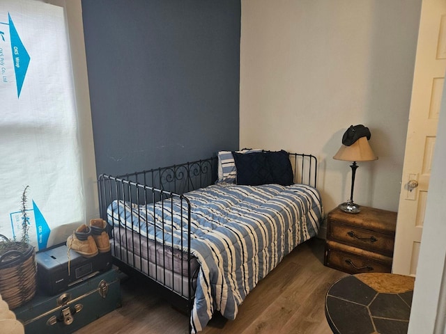 bedroom with dark wood-type flooring