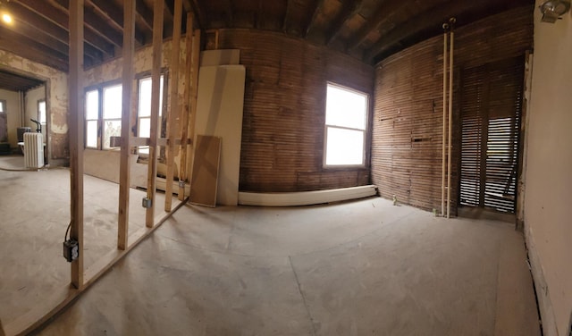 interior space with radiator heating unit and brick ceiling