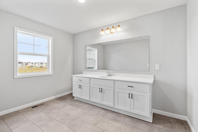 bathroom featuring tile patterned flooring and vanity