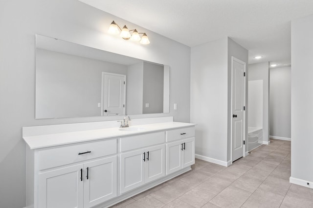 bathroom featuring vanity, tile patterned floors, and a textured ceiling