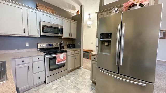 kitchen with stainless steel appliances and hanging light fixtures