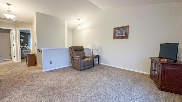 sitting room with vaulted ceiling and light colored carpet