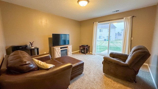 living room with light colored carpet and a textured ceiling