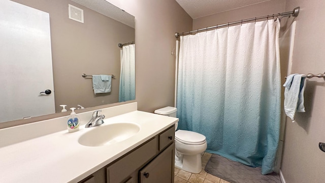 bathroom featuring vanity, toilet, and a textured ceiling