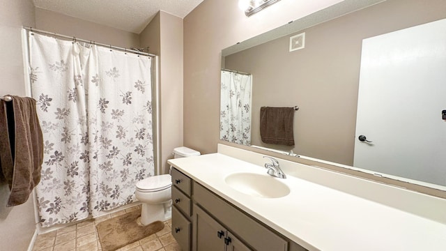 bathroom featuring vanity, toilet, and a textured ceiling