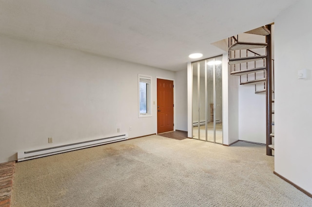 carpeted spare room featuring a baseboard radiator