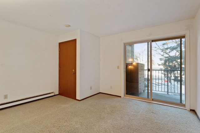 spare room with light carpet and a baseboard heating unit