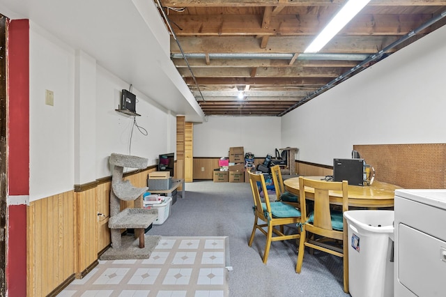 basement with wood walls and washer / dryer