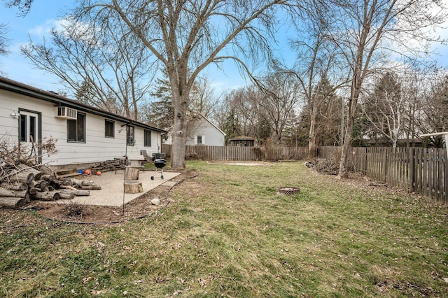 view of yard featuring a patio, an outdoor fire pit, and a wall mounted AC