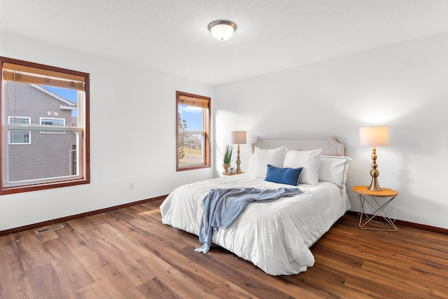 bedroom with wood-type flooring