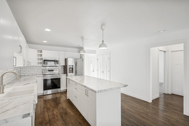 kitchen featuring pendant lighting, a center island, dark hardwood / wood-style flooring, and stainless steel appliances