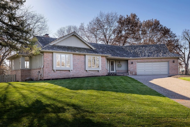 ranch-style home featuring a garage and a front lawn