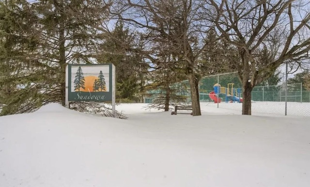 yard layered in snow with a playground