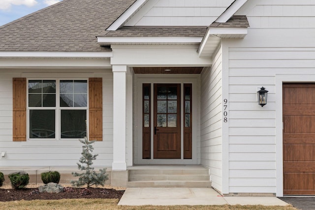 doorway to property with a garage