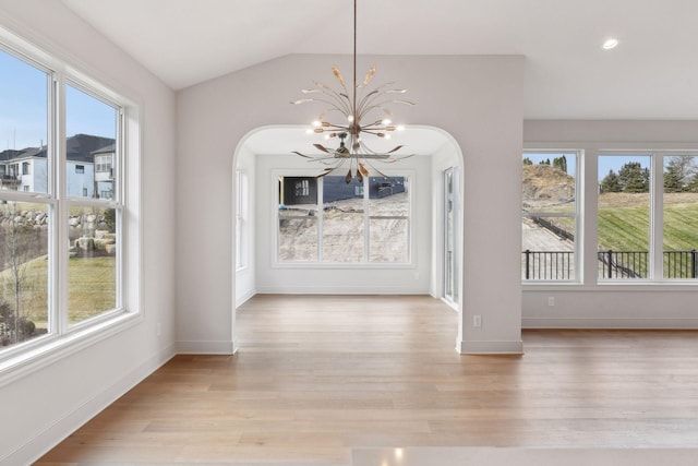 unfurnished dining area with light hardwood / wood-style floors and a wealth of natural light