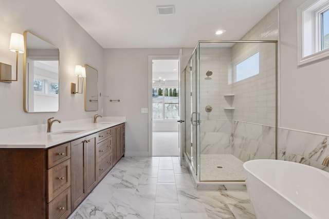 bathroom with vanity, separate shower and tub, and plenty of natural light