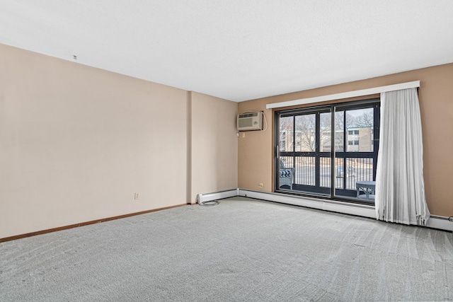 carpeted spare room with a wall unit AC and a baseboard radiator