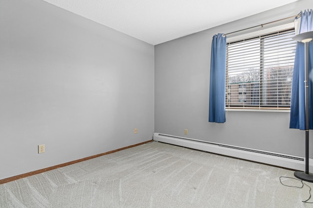 unfurnished room with light carpet and a baseboard heating unit