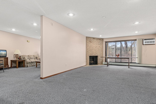 unfurnished living room with carpet, a textured ceiling, a wall mounted AC, a baseboard radiator, and a fireplace