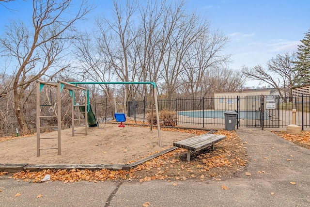 view of jungle gym with a community pool