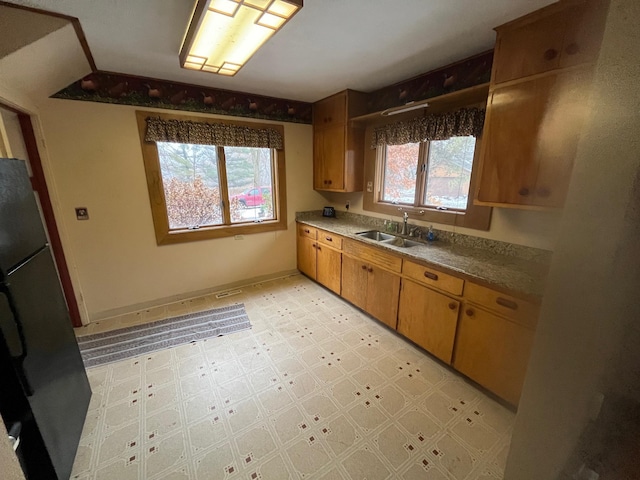 kitchen with stainless steel fridge and sink