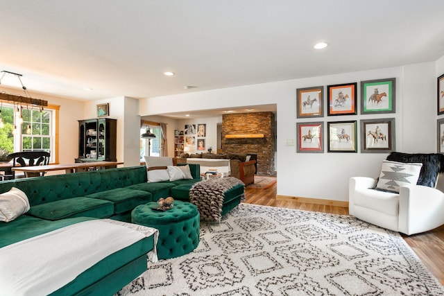 living room with light wood-type flooring and a fireplace