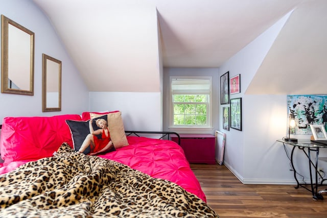 bedroom featuring dark hardwood / wood-style floors and lofted ceiling