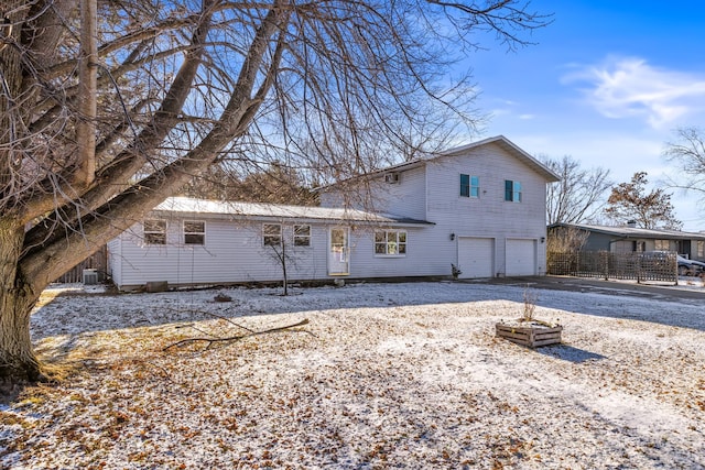 rear view of property with a garage