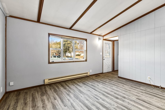 spare room with lofted ceiling with beams, a baseboard radiator, light hardwood / wood-style floors, and wood walls