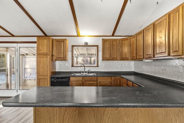 kitchen featuring kitchen peninsula, sink, lofted ceiling with beams, black dishwasher, and light hardwood / wood-style floors