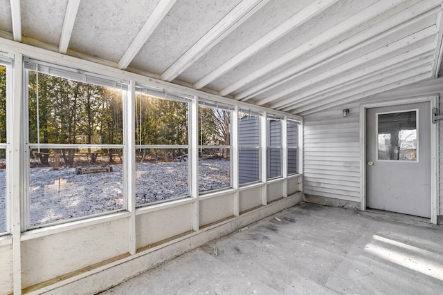 unfurnished sunroom featuring a wealth of natural light and lofted ceiling