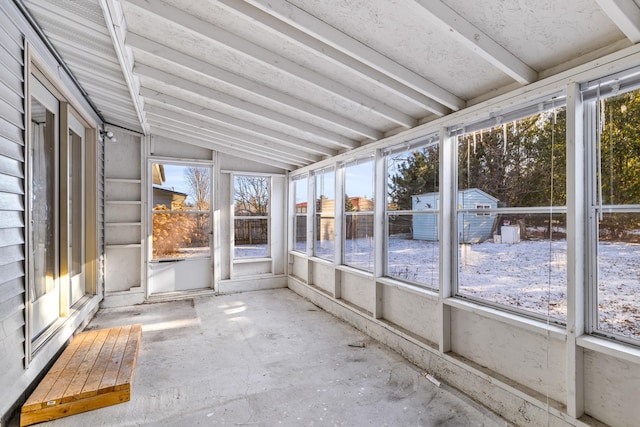 unfurnished sunroom with plenty of natural light and lofted ceiling