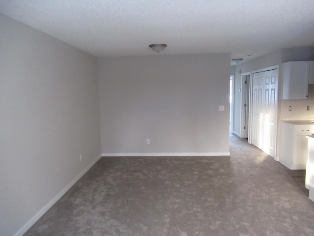 carpeted spare room with a textured ceiling