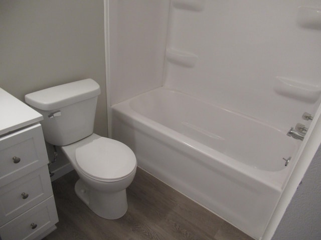 full bathroom featuring wood-type flooring, vanity, toilet, and  shower combination