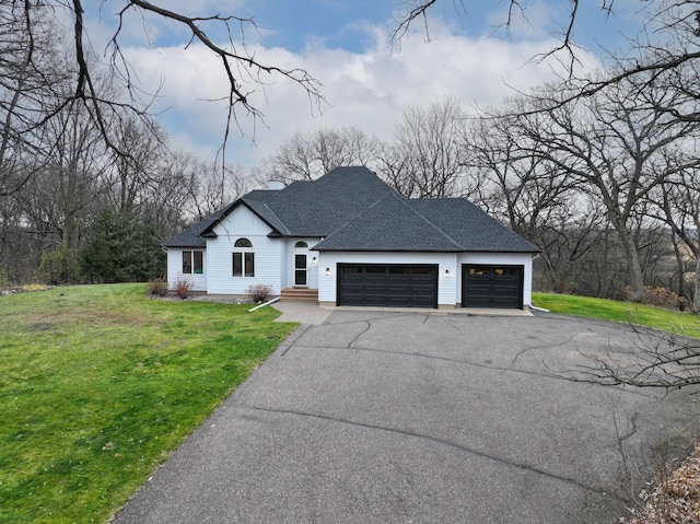 view of front facade with a front yard and a garage