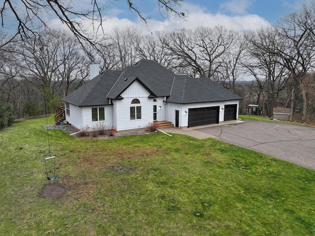 view of front of home featuring a garage and a front lawn